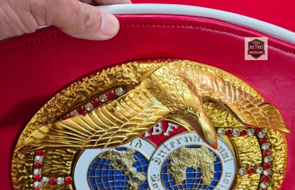 Detailed view of IBF championship belt replica showing thick heavyweight metal plates