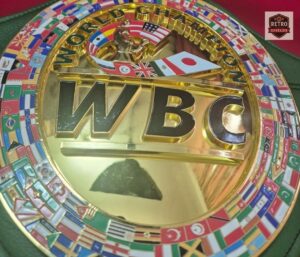 Collector-grade WBC championship belt replica on green leather strap