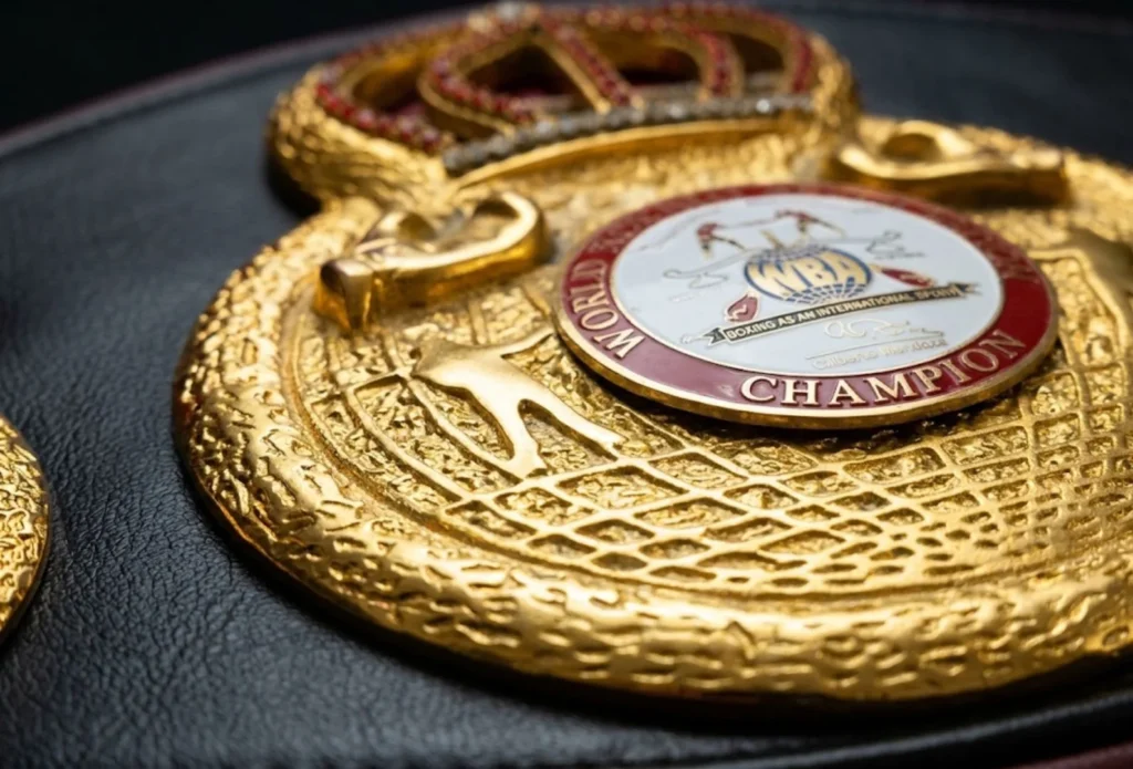 Close up of gold tone plating on the center plate of a championship belt